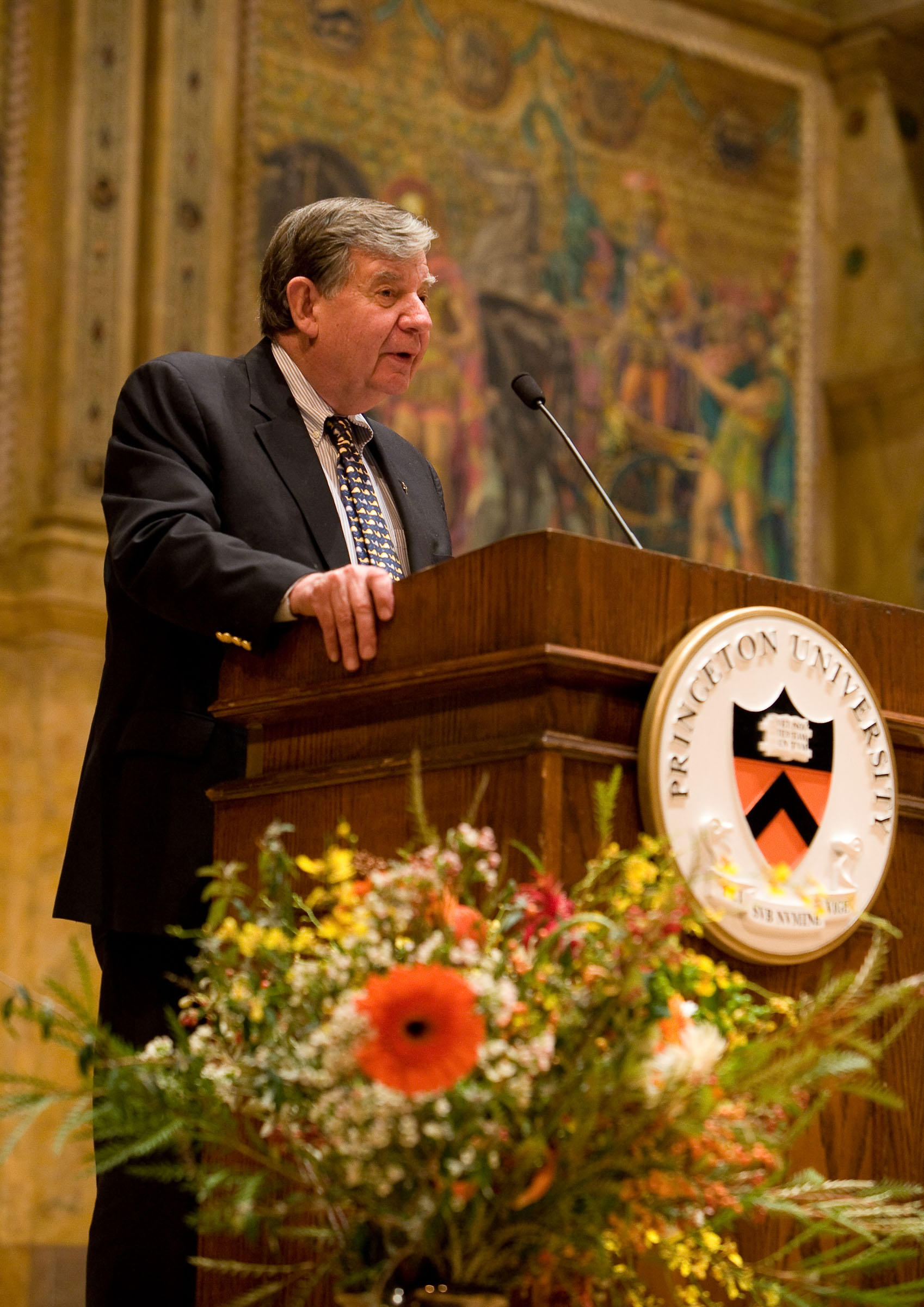 Photo of man standing at a Princeton University lectern, giving a speech.