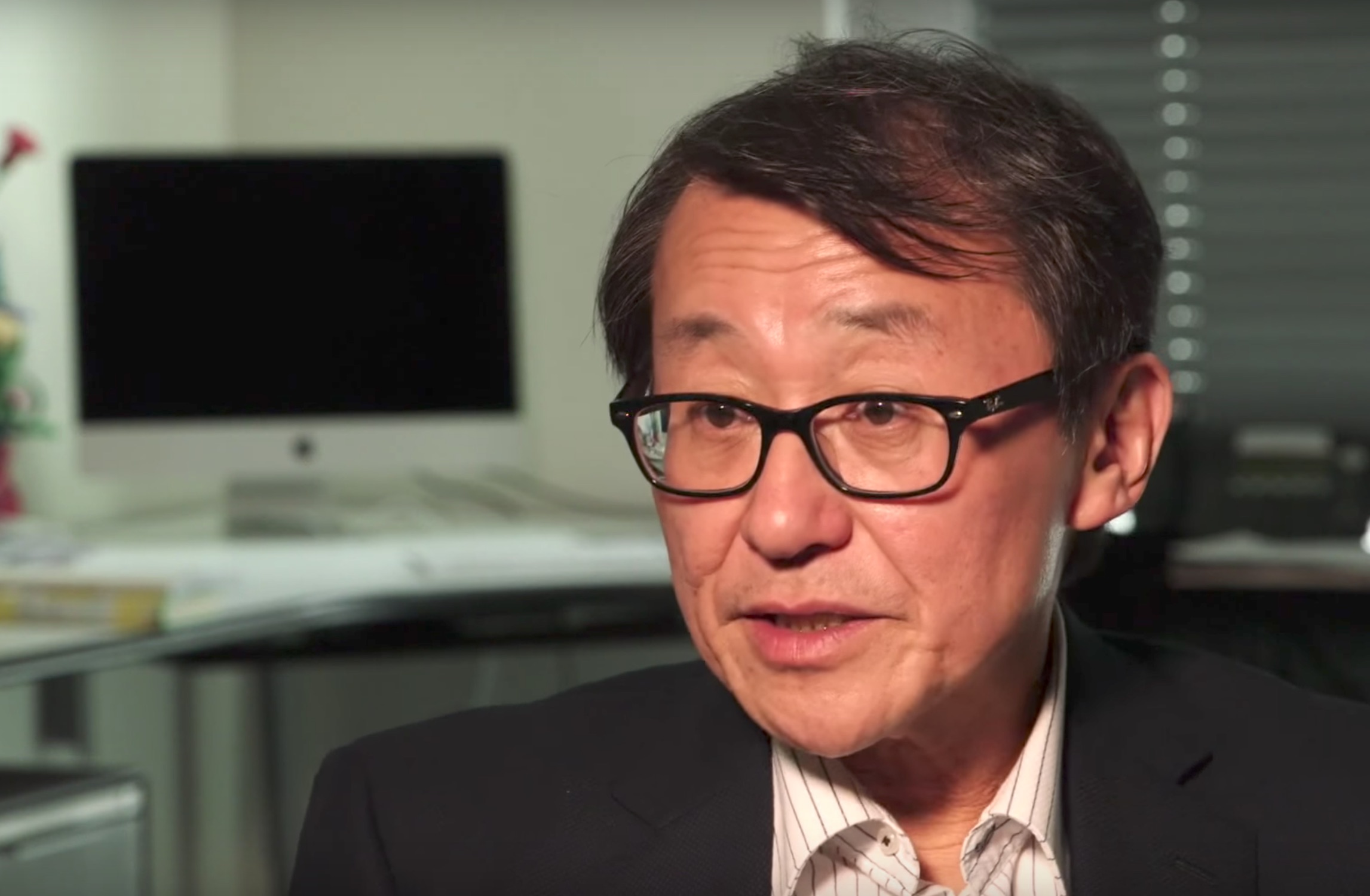 Photo (video screengrab) of Professor Miyagawa speaking while seated at a desk.